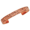 Copper bracelet with embossed design on a white background