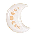 Ceramic moon-shaped decorative item with engraved symbols on a white background