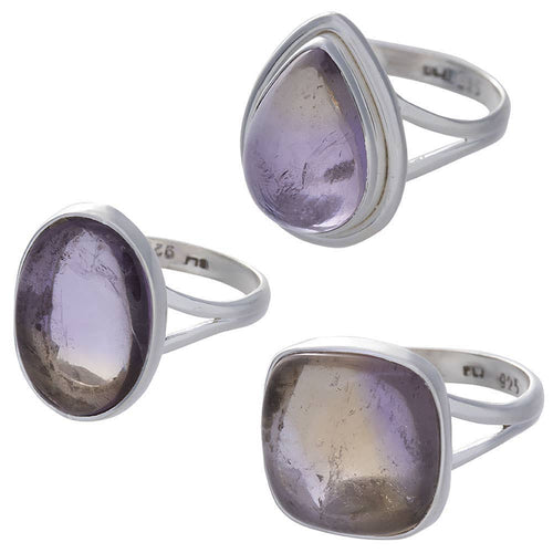 Three silver ametrine rings with purple gemstones on a white background