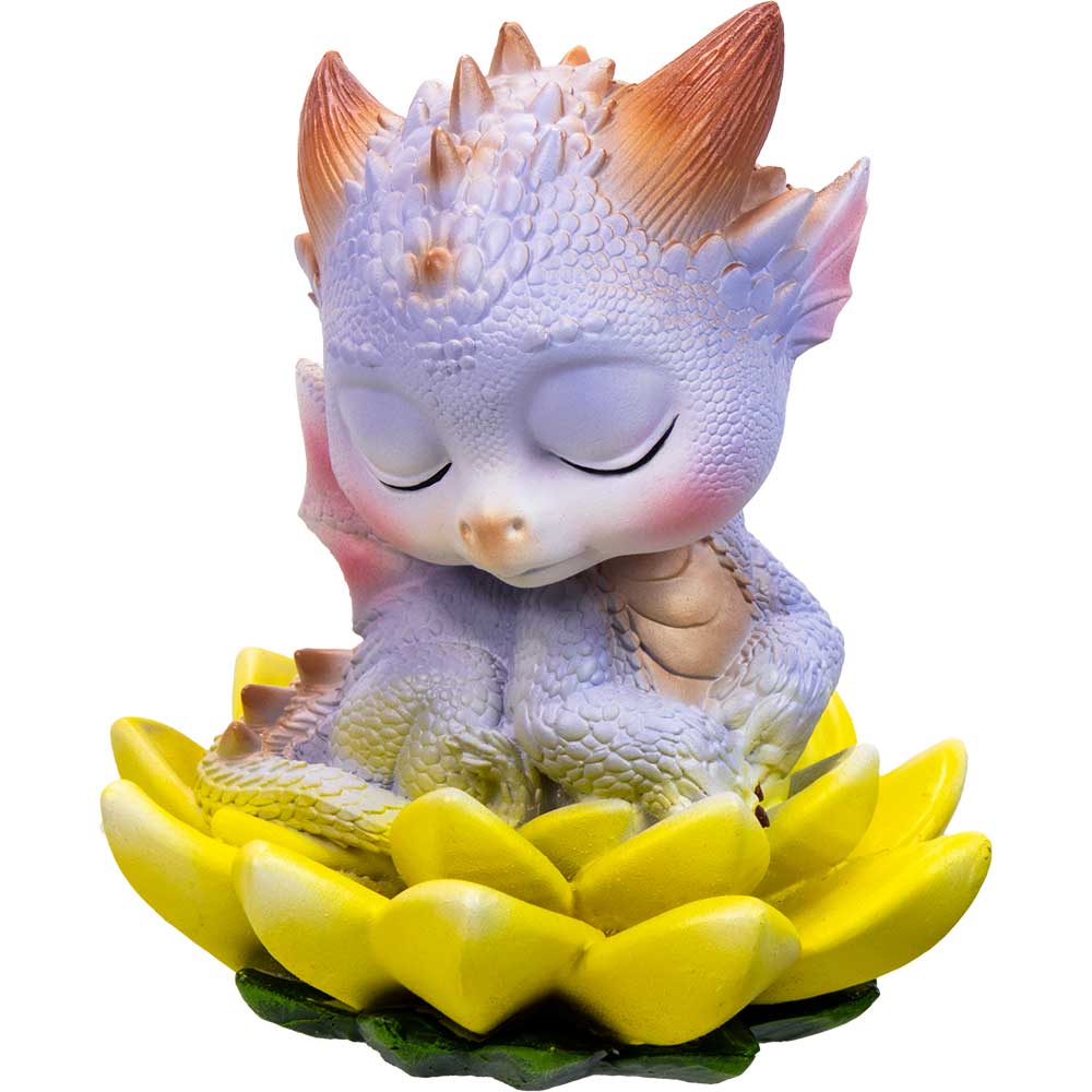 Cute dragon figurine with closed eyes on a yellow flower