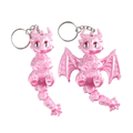 Two pink dragon keychains with silver metal key rings, shown against a plain white background.