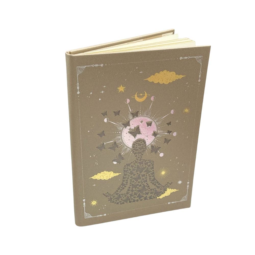 Decorative notebook with star and moon design on a beige background