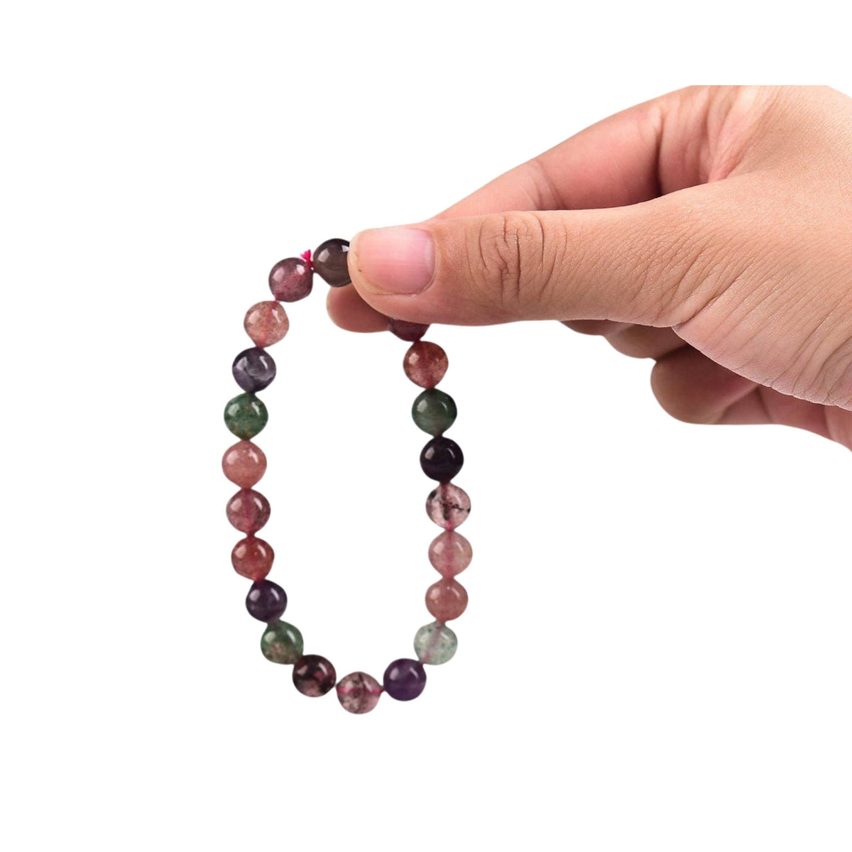 A hand holds a beaded bracelet made of round, translucent strawberry quartz gemstone beads in pink, purple, green, and red tones.