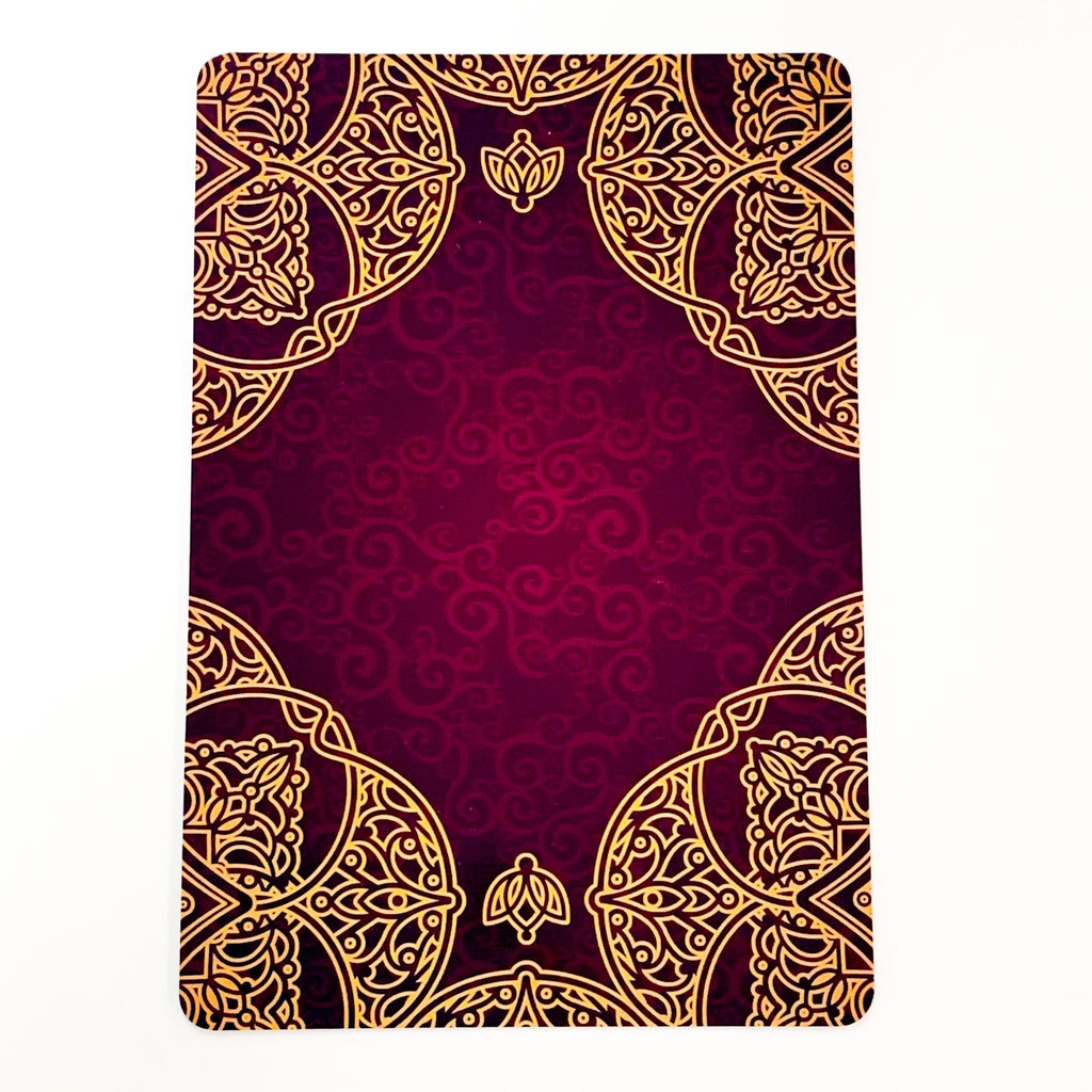 Decorative notebook with gold mandala design on a red background