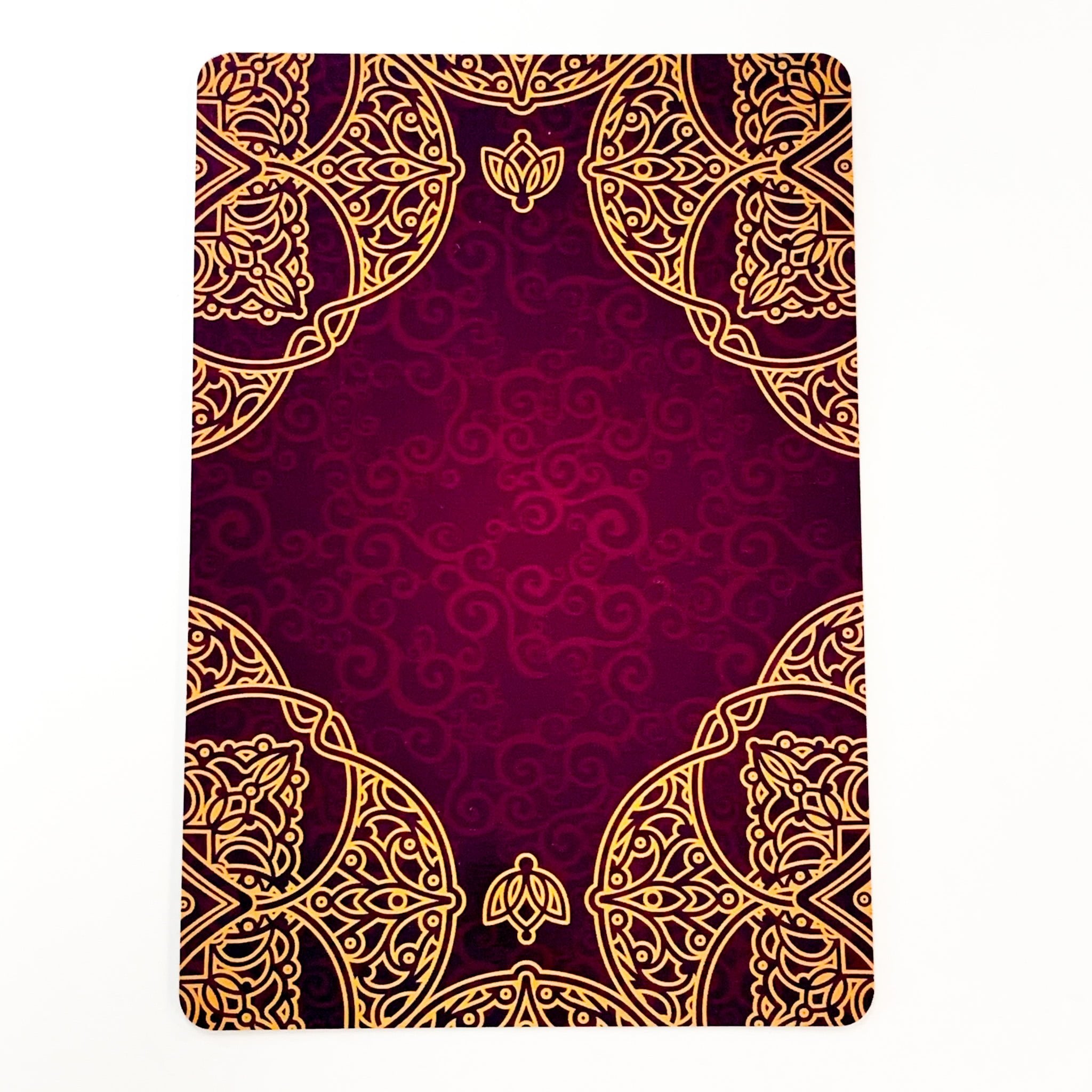 Decorative notebook with gold mandala design on a red background