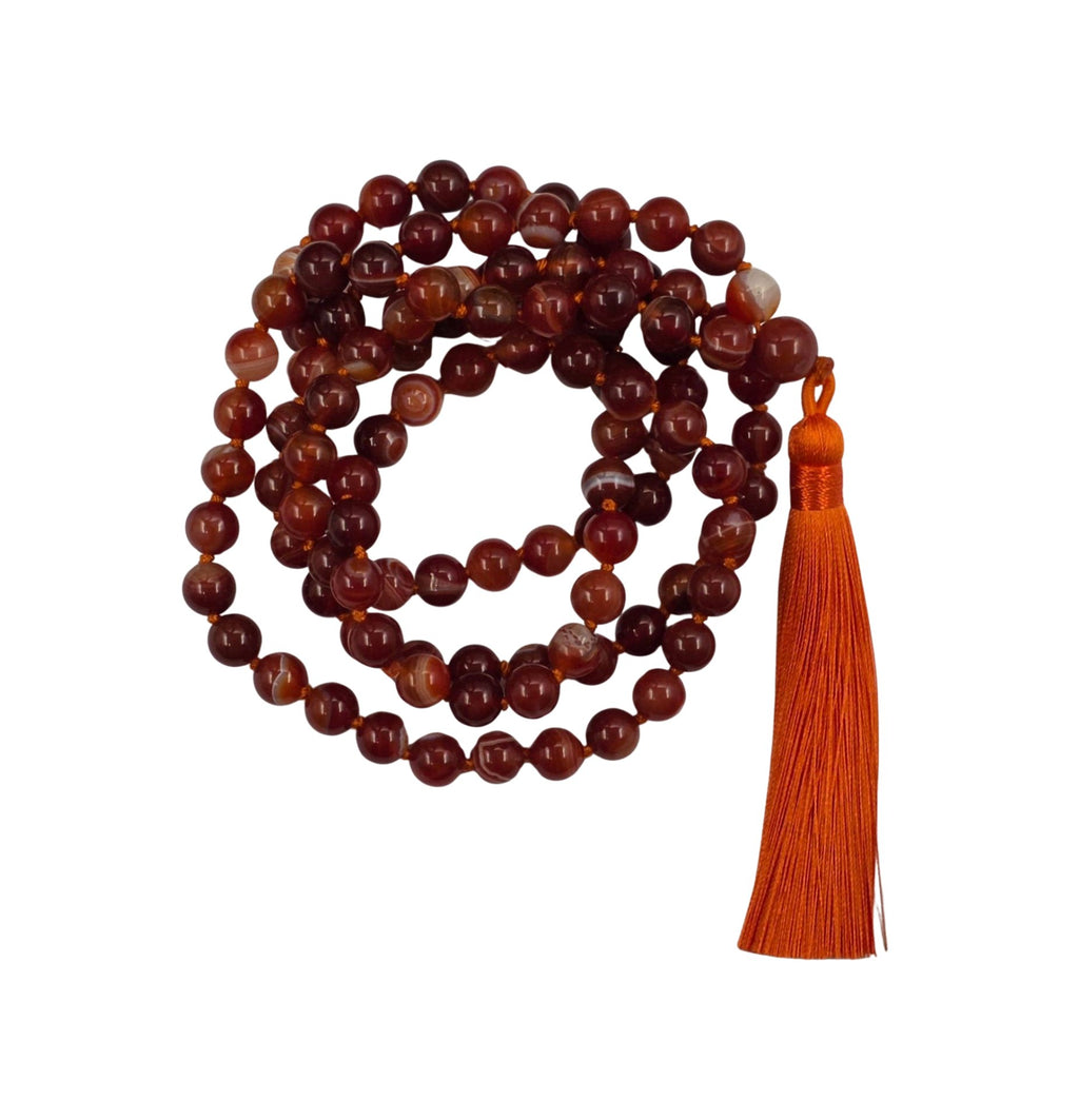 A long strand of polished red and brown carnelian beads 