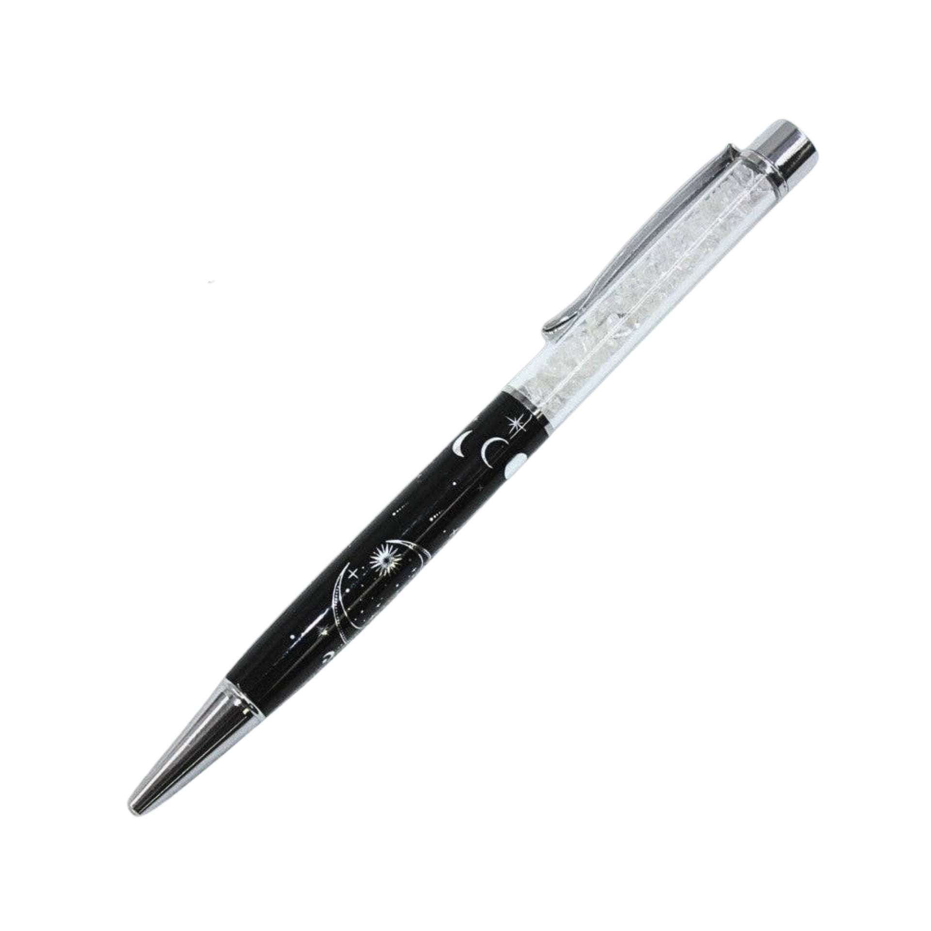 A black and silver ballpoint pen with a clear, glittery cap, featuring a celestial design of crescent moons and stars on the barrel.