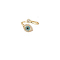 A gold-toned evil eye ring with a central turquoise and black eye motif, surrounded by small clear stones, on a plain white background.