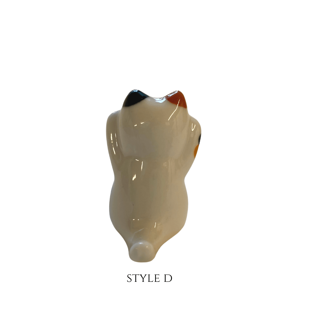 Beige ceramic torso sculpture on a white background