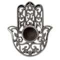 Decorative metal Hamsa hand mini candle holder with intricate designs on a white background