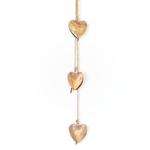 Three gold heart-shaped decorations hanging on a string against a white background