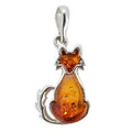 A silver pendant charm shaped like a sitting cat, featuring a translucent amber-orange cabochon stone for the body and head, set against a plain white background.