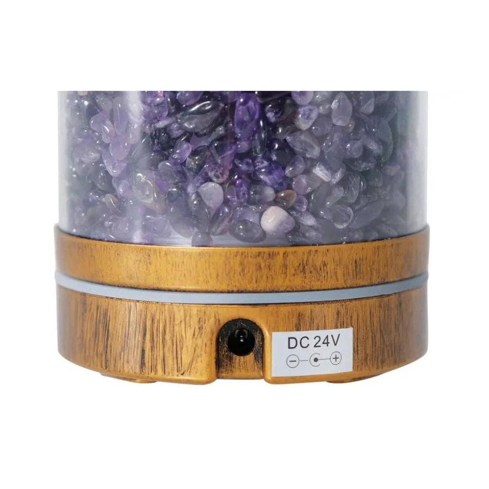 Decorative lamp with wooden base and purple crystal stones on a white background