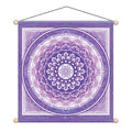 A square purple wall hanging tapestry featuring a large circular mandala design in shades of lavender and purple, with a central geometric symbol. The tapestry has a hanging cord and wooden beads at the corners, shown against a plain white background.