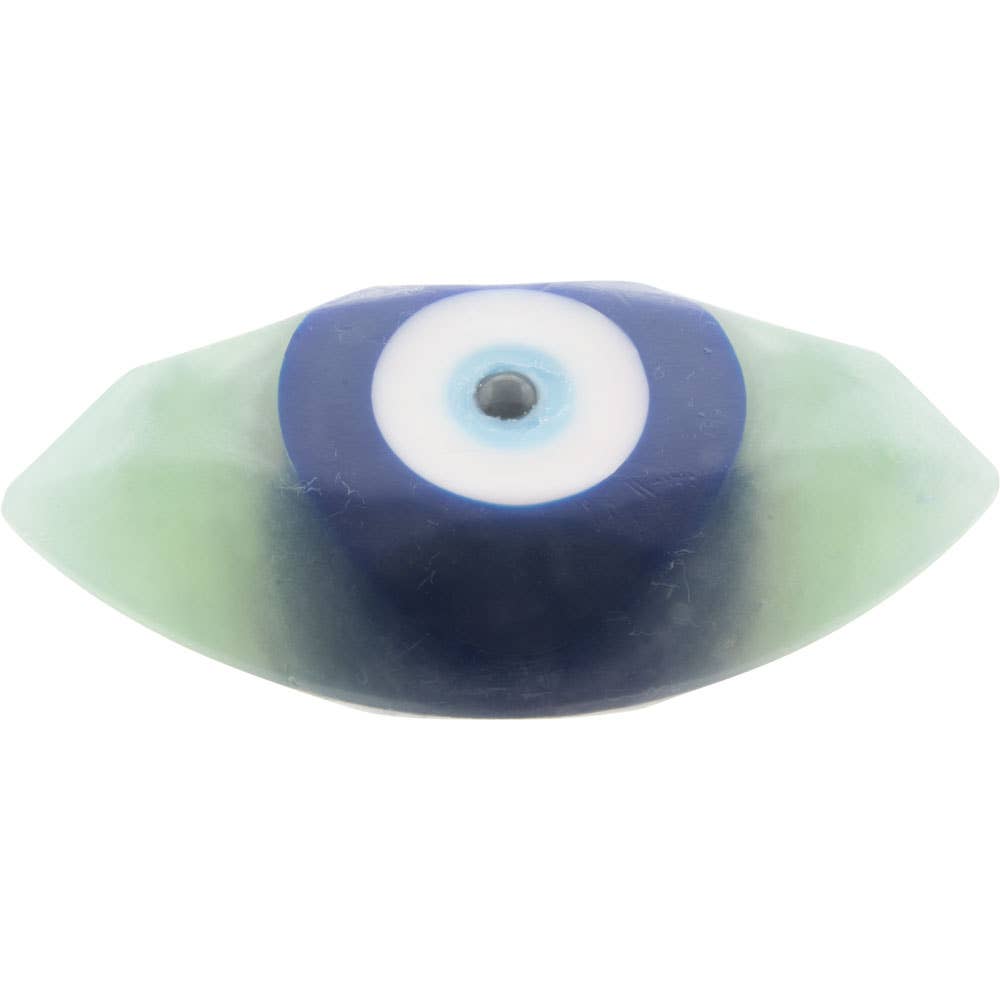 A single evil eye body soap with a blue outer ring, white center, and light blue pupil, set in a translucent pale green material, shown on a plain white background.
