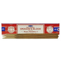 A box of Satya Nag Champa Dragon's Blood Incense sticks, with several light brown incense sticks visible at the bottom, set against a plain white background.