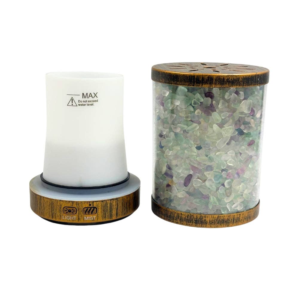 Aroma diffuser with wooden base and glass container filled with Fluorite beads on a white background