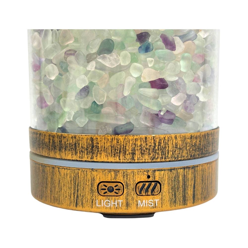A diffuser with a wooden base and Fluorite stones inside on a white background