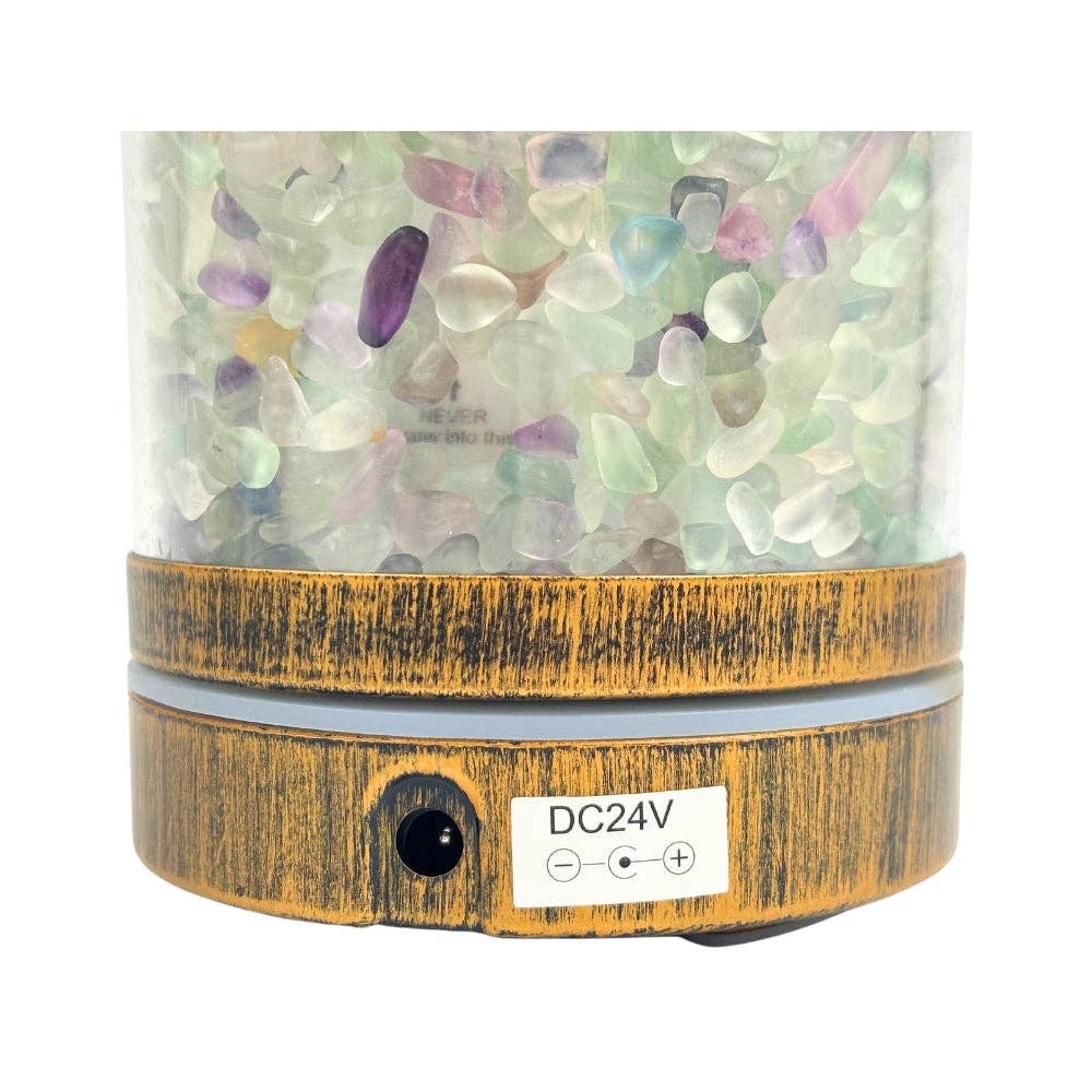 Decorative lamp with Fluorite stones inside and a wooden base on a white background
