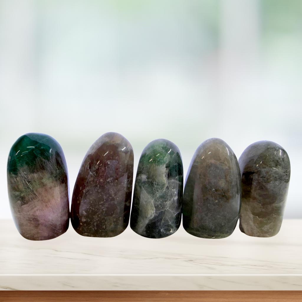 Fluorite Free Form Standing Pieces lined up in a window sill