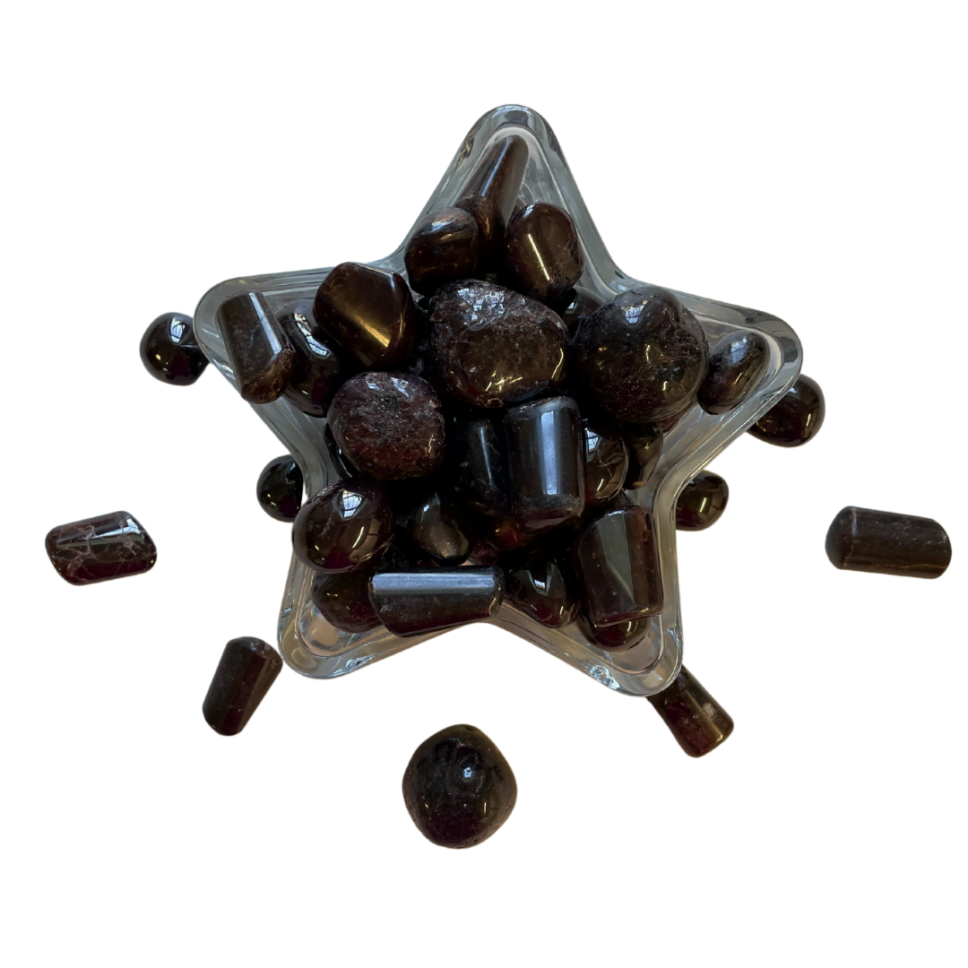 Star-shaped container filled with dark brown stones on a white background