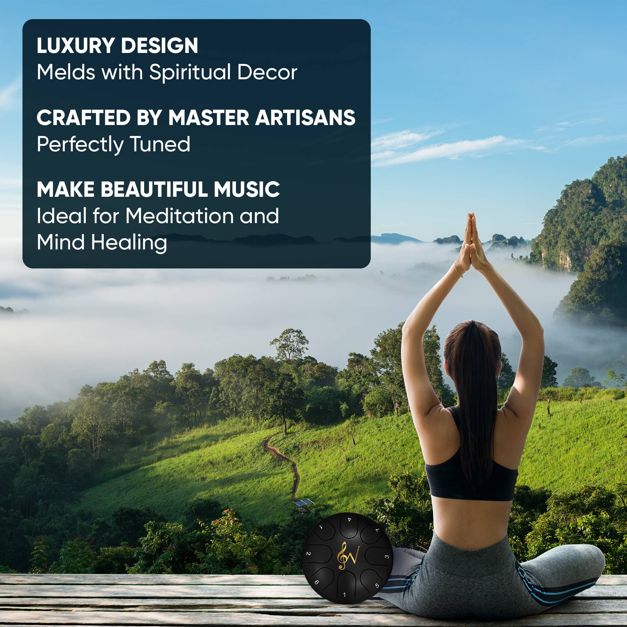 Happy Drum next to a person meditating with a view over foggy mountains