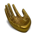 Decorative gold hand with intricate patterns on a white background