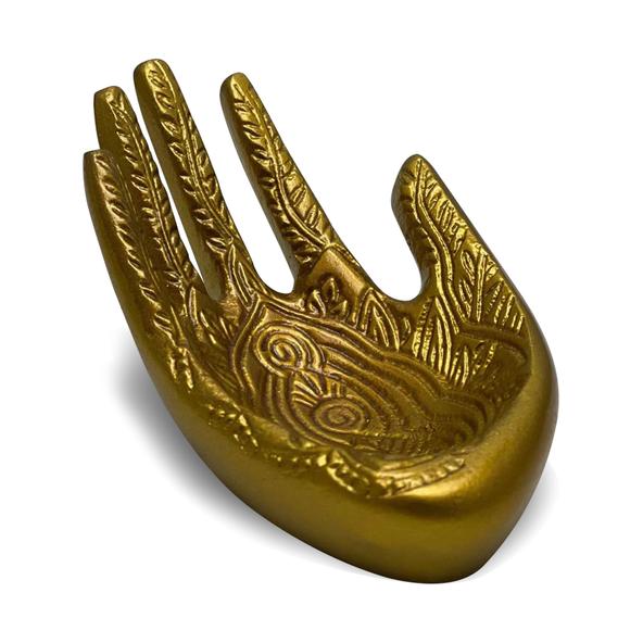 Decorative gold hand with intricate patterns on a white background