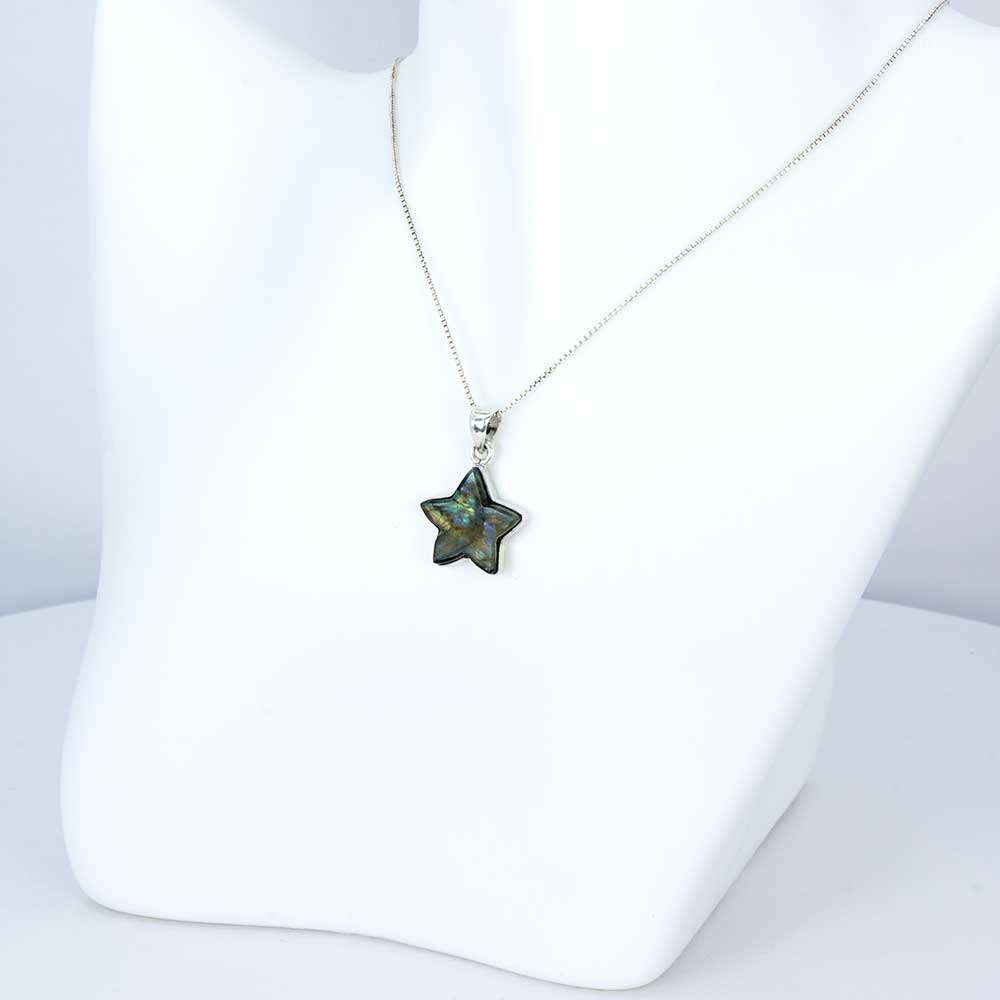 Star-shaped pendant on a white stand with a white background