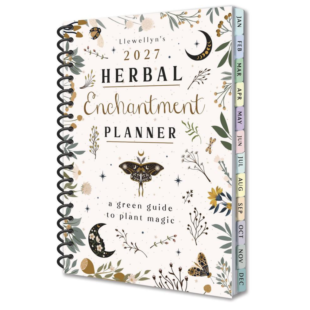 Llewellyn's 2027 Herbal Enchantment Planner, featuring a cream-colored cover decorated with botanical illustrations, a butterfly, crescent moons, and a black spiral binding. The colorful monthly tabs along the side are labeled for the months of the year.
