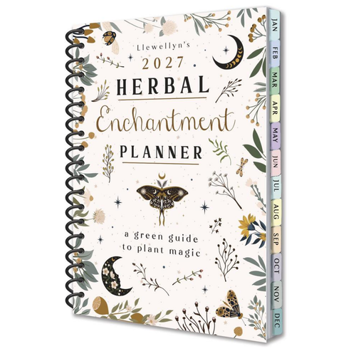 Llewellyn's 2027 Herbal Enchantment Planner, featuring a cream-colored cover decorated with botanical illustrations, a butterfly, crescent moons, and a black spiral binding. The colorful monthly tabs along the side are labeled for the months of the year.