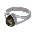 Moldavite Ring Set in Sterling Silver with a Teardrop Shaped faceted stone on a white background.