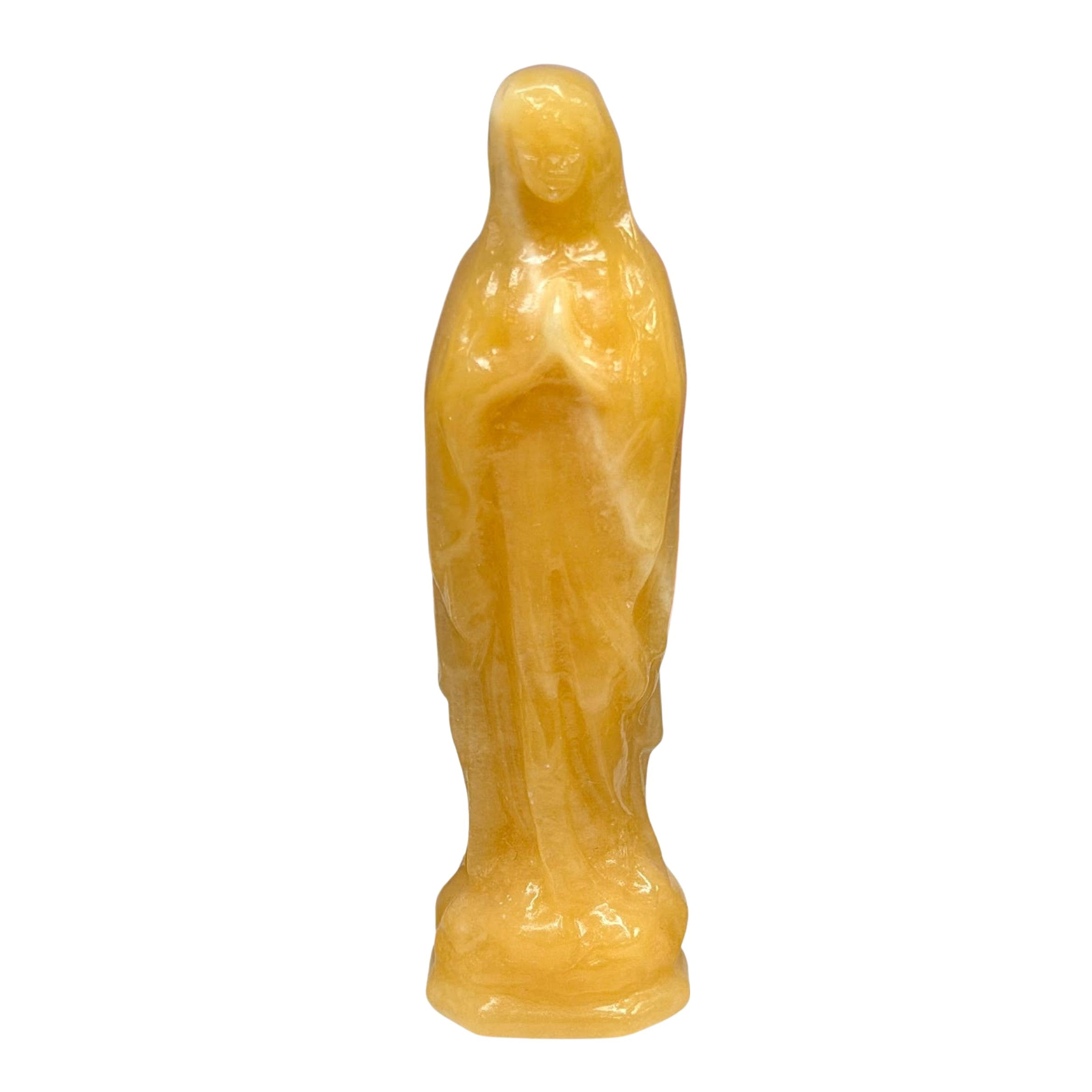An Orange Calcite figurine of the Virgin Mary, standing on a plain white background.