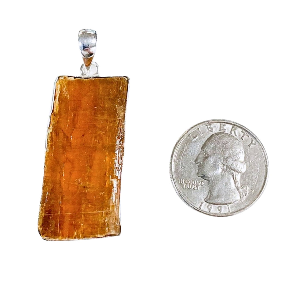 Orange Kyanite Pendant with Quarter on White Background
