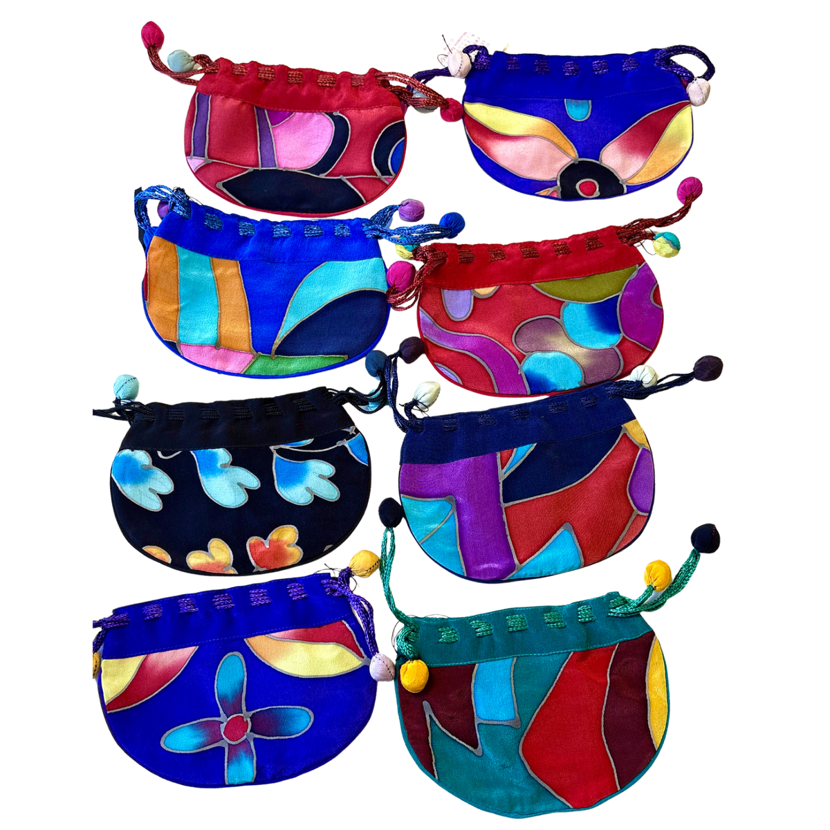 Many Rainbow Silk Bags in various colors on a white background.