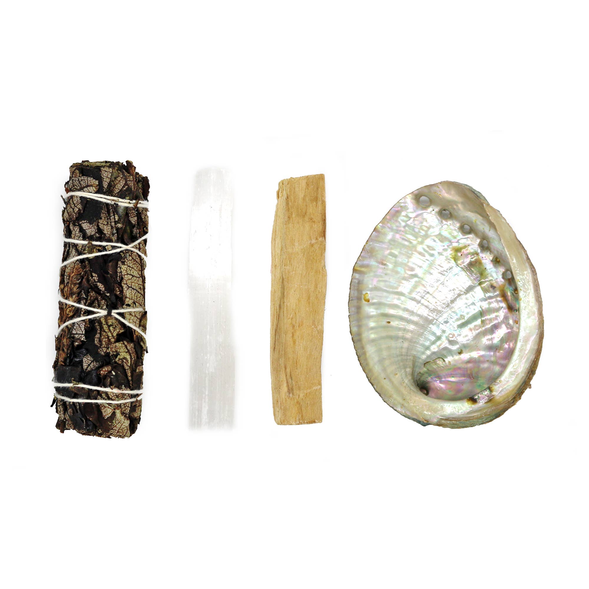 Set of spiritual tools including a sage bundle, crystal, palo santo stick, and abalone shell on a white background