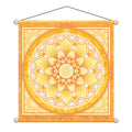 A square hanging wall art piece featuring a large yellow and orange mandala design with a central geometric flower motif. The artwork has a decorative border, a hanging cord, and round finials at the corners, shown on a plain white background.