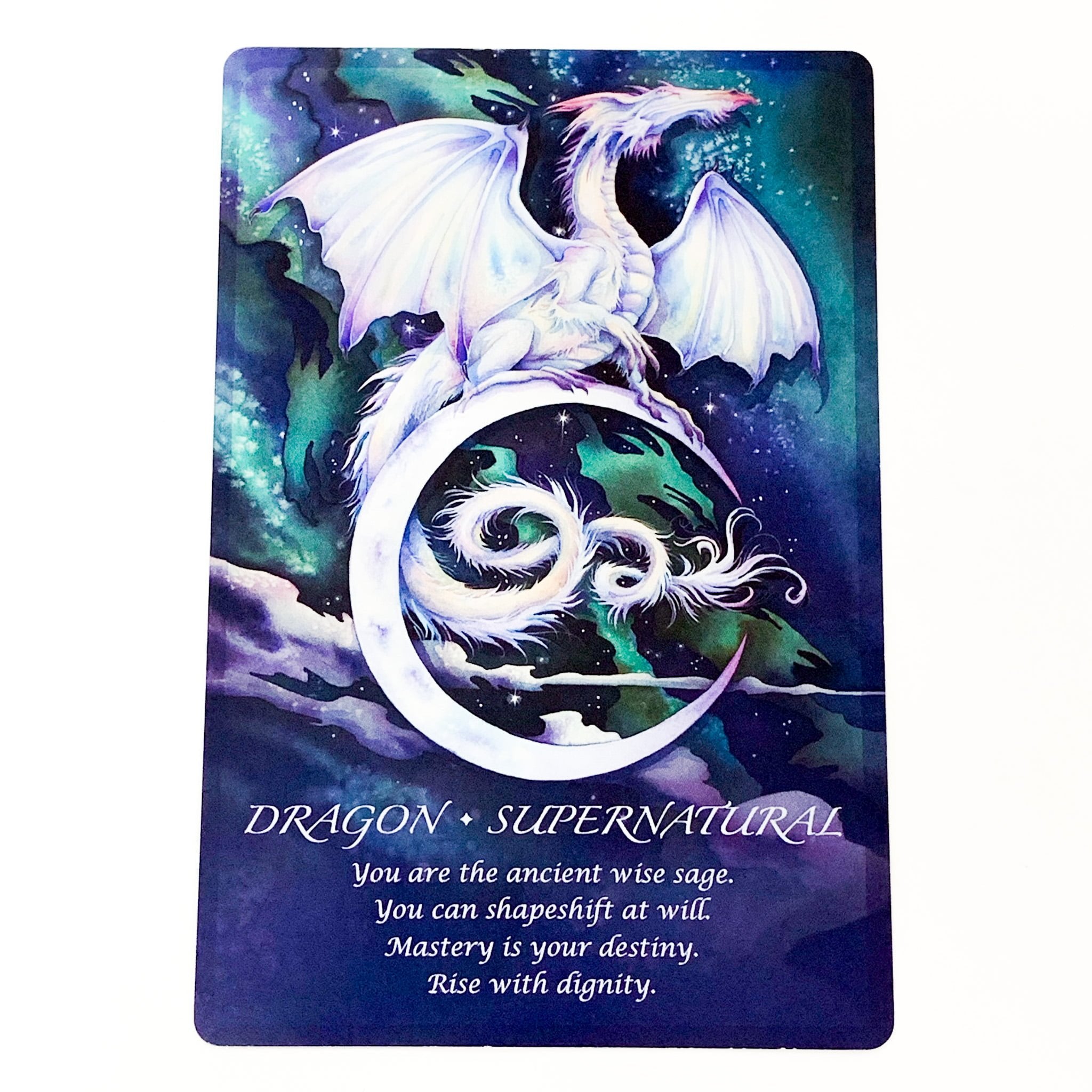 Card with a dragon and moon design, featuring text about a 'Supernatural Dragon'.
