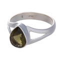 Three silver rings with faceted moldavite gemstones on a white background