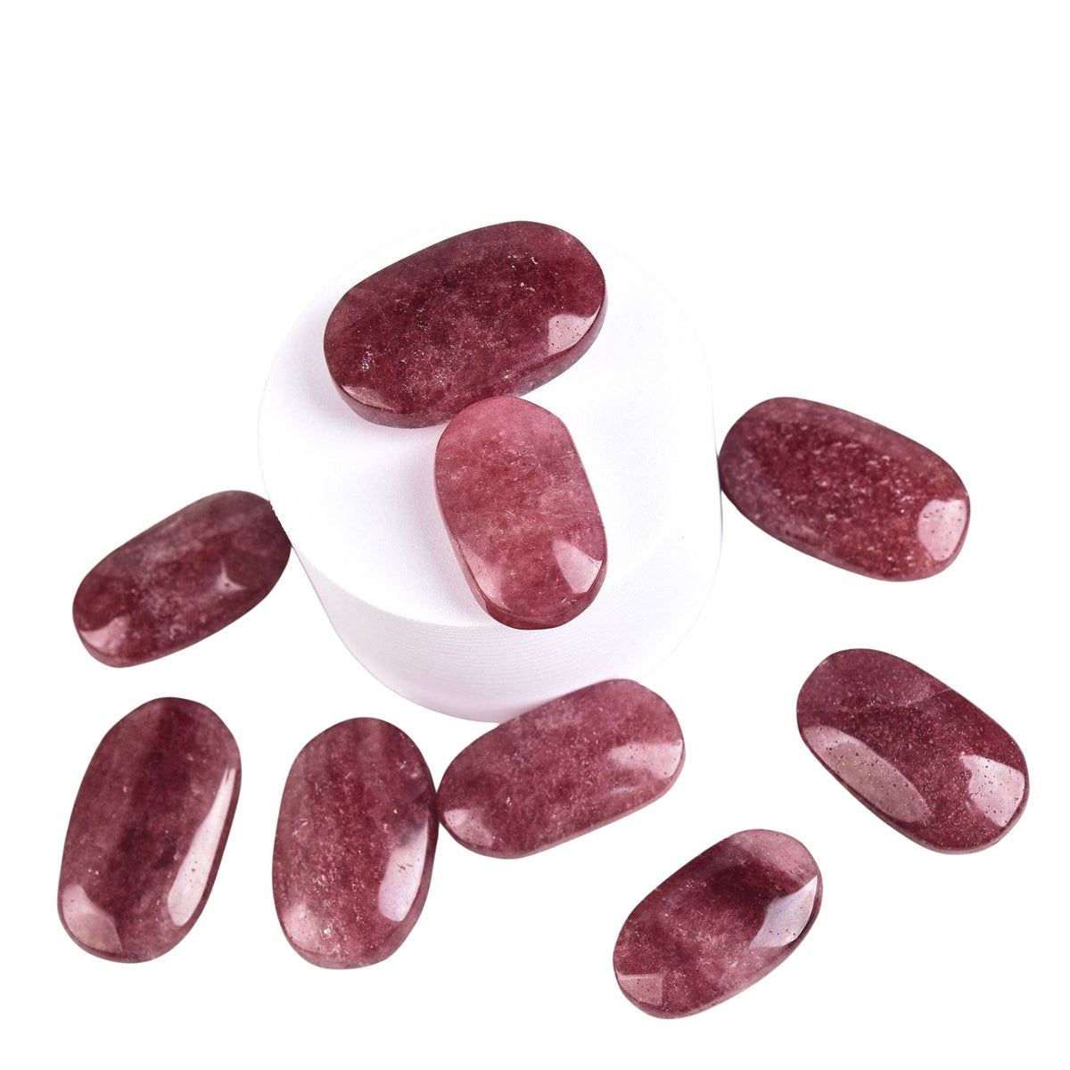 Nine Strawberry Quartz Palm Stones on a white background