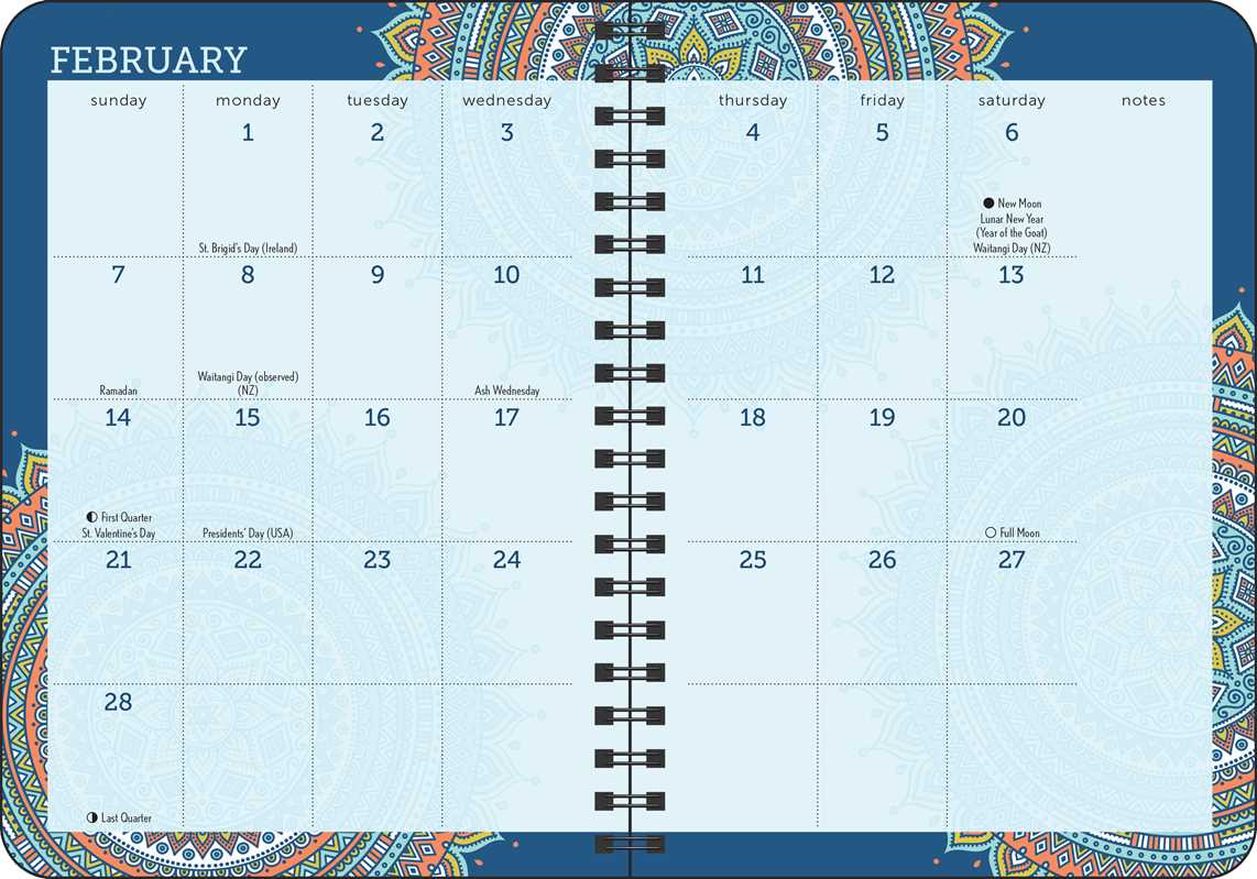 A February calendar page from a spiral-bound planner with a decorative mandala-style border. The page shows dates from 1 to 28 in a light blue grid, with black spiral binding down the center and blue header text reading 'FEBRUARY'.