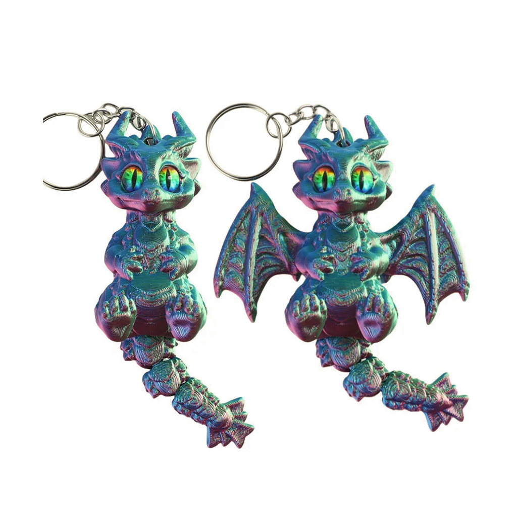 Two small dragon keychains with metallic iridescent blue, green, and purple finish, shown on a plain white background.