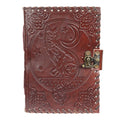 Brown leather journal with embossed design of a wolf and moon on a white background