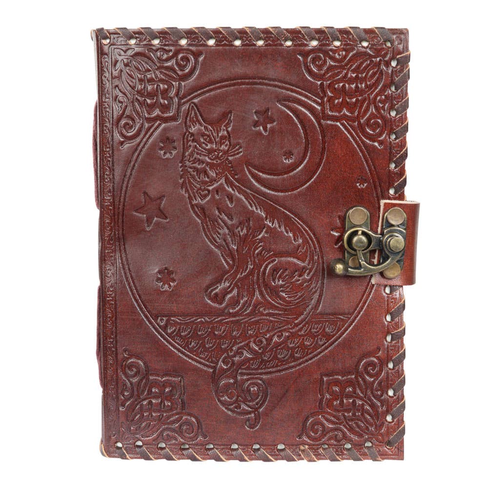 Brown leather journal with embossed design of a wolf and moon on a white background