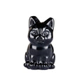 A glossy black obsidian cat figurine, likely made of polished stone or resin, is shown against a plain white background.