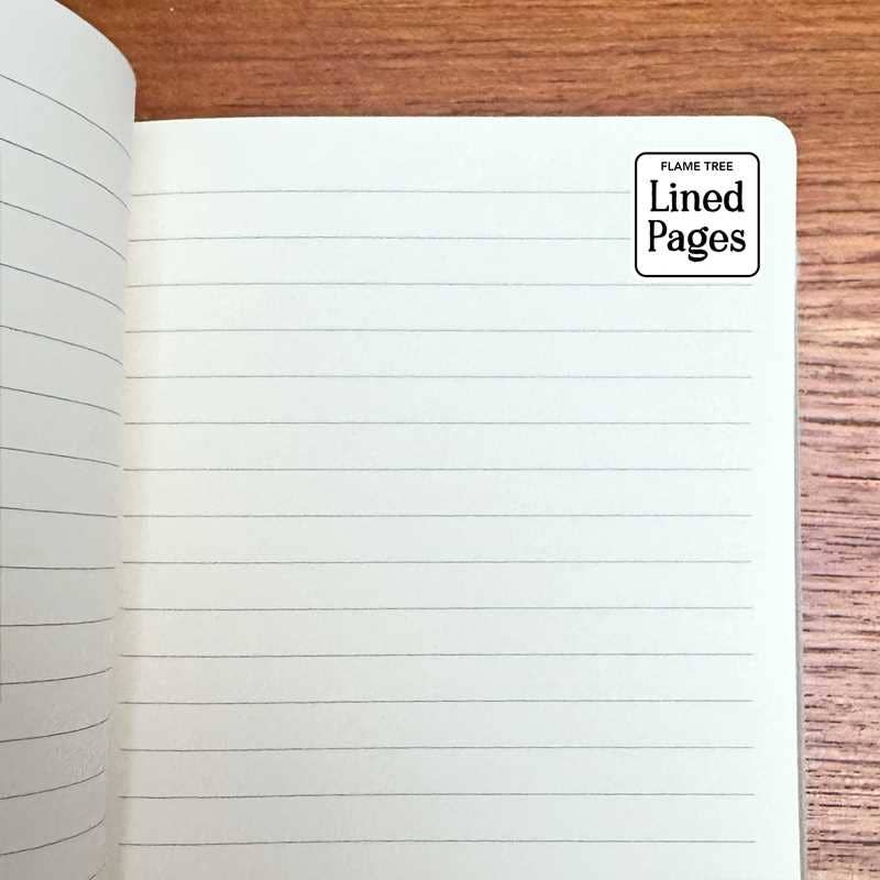 Open notebook with lined pages on a wooden surface, featuring the 'Flame Tree' brand.