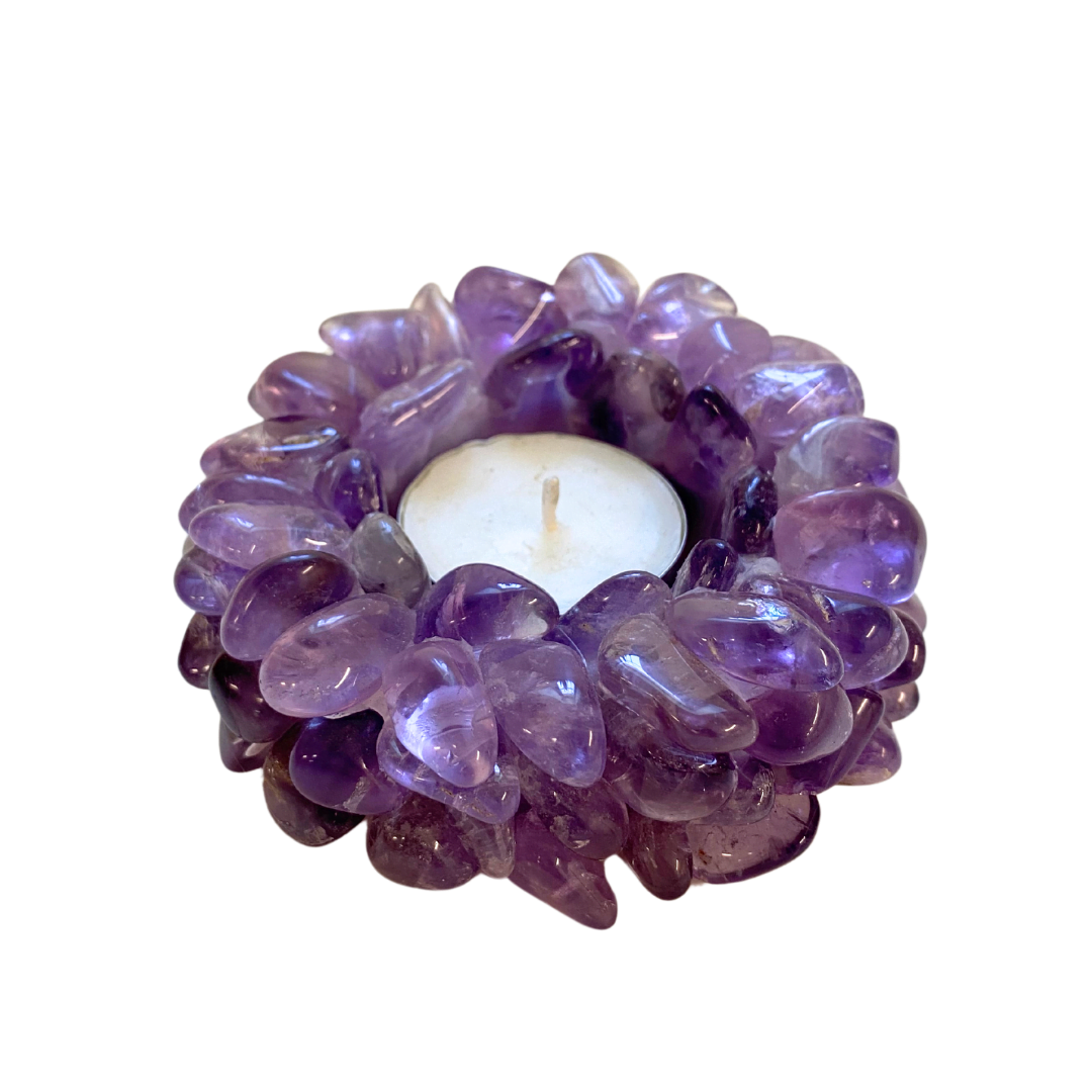 Candle holder made of purple amethyst stones on a white background