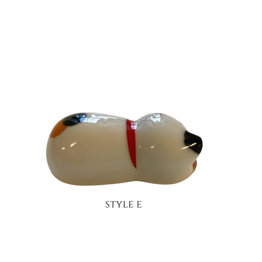 Glass cat figurine with a red collar on a white background