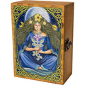 A rectangular wooden box with a hinged lid, featuring a hand-painted folk art illustration of a seated female figure in a blue robe with green hair and a yellow flower crown, framed by Celtic knot borders. The box is made of light brown wood and has a metal latch on the side.