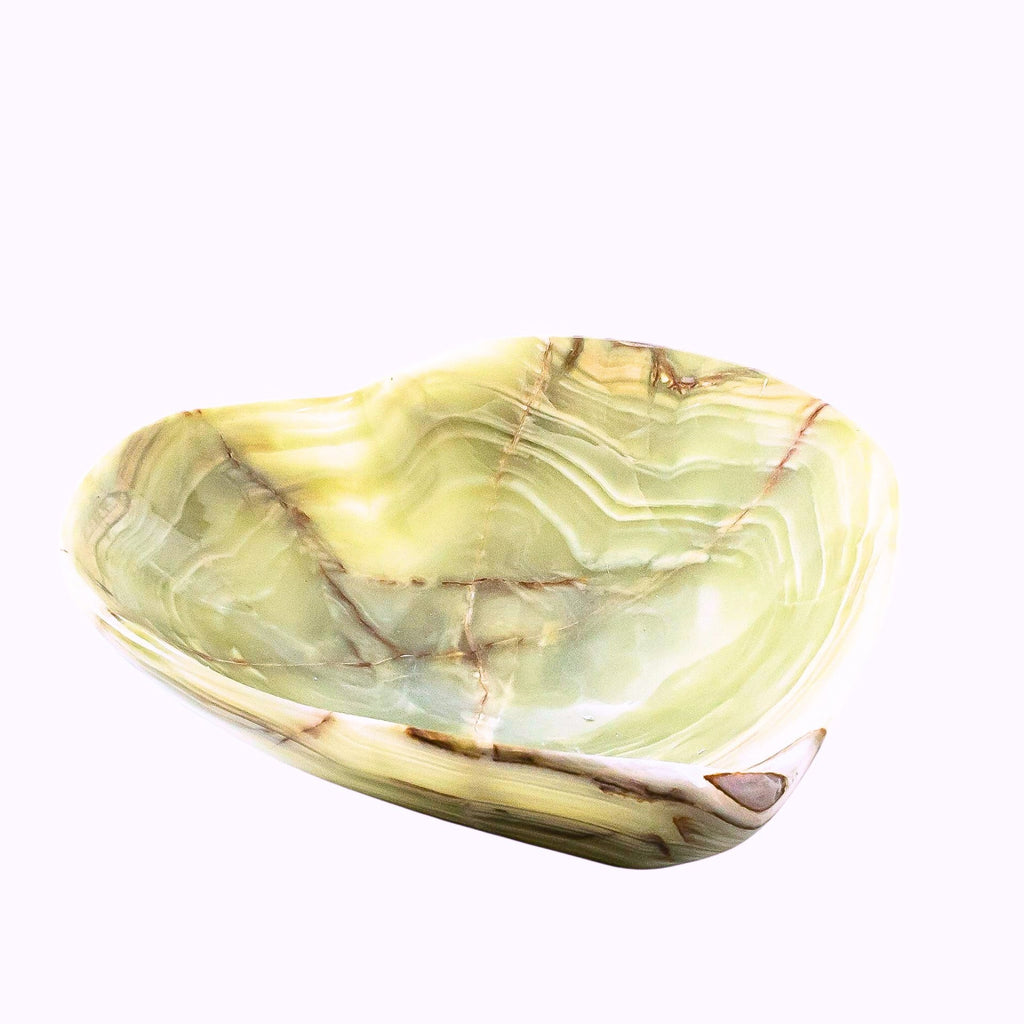 A polished stone bowl made from light green and cream agate with natural brown veining, shown on a plain white background.
